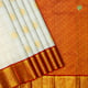 Milk White With Gold Zari Checked And Thilagam Butta Motifs Design Brick Red With Gold Zari Multi Design Big Circles Butta Motifs Border Traditional Silk Saree